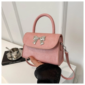 Pink bow handbag featuring metallic silver bow detail and adjustable shoulder strap