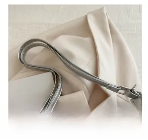 Detailed macro view of the silver leather bag handle with premium metallic finish