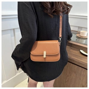 Chic caramel brown leather crossbody square bag shown on model for size and style reference