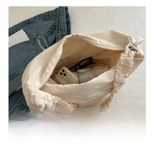 Spacious beige pleated tote bag showing interior storage for daily essentials