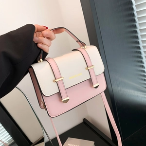Pink and white contrast leather handbag with gold buckle and adjustable strap