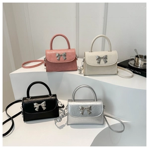 Collection of four chic mini handbags with metallic bow details in various colors
