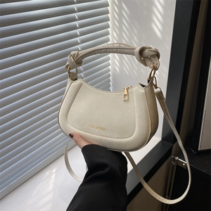 Chic cream white leather saddle bag with knot handle and adjustable shoulder strap