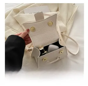 Detail showing internal capacity of white crocodile pattern handbag with magnetic closure