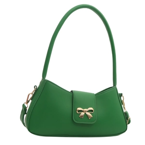 Fashionable bright green faux leather shoulder bag with a gold bow buckle on white background