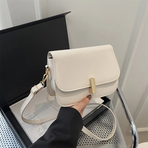 Minimalist beige crossbody bag with gold lock and adjustable strap for women