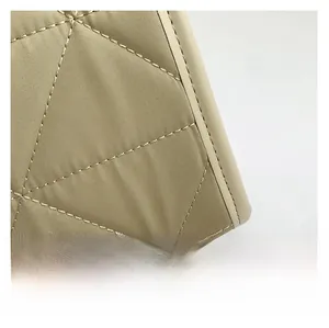 Macro shot of rhombus quilted fabric texture and precision stitching on the tote bag