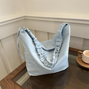 Large light blue canvas dumpling tote bag with drawstring pleated design for women