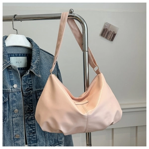 Close-up of light pink large capacity tote bag with wide shoulder strap and zipper
