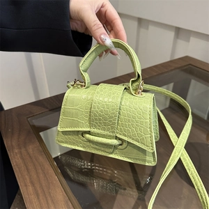 Chic light green crocodile embossed mini handbag with curved base and top handle