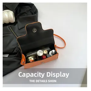 Interior view of the orange leather crossbody bag showing space for phone and makeup