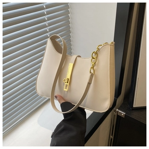 Detailed view of the gold buckle and chain on an off-white half-moon hobo bag
