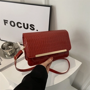 Red crocodile embossed patent leather crossbody bag with gold metal buckle decoration
