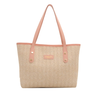 Chic beige woven straw tote bag with pink leather handles and gold rivet accents