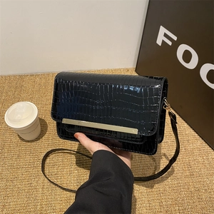 Retro black crocodile pattern crossbody bag with minimalist gold metal trim and flap