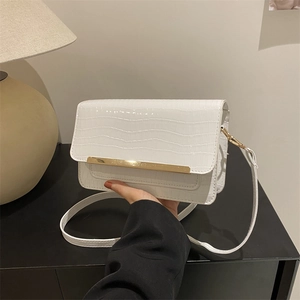 White faux leather crossbody bag with crocodile texture and gold metal bar detail