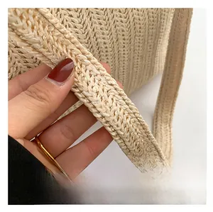 Close-up of beige herringbone woven strap on a minimalist summer straw tote bag
