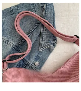 Close-up of pink corduroy tote bag featuring fine ribbed texture and sturdy handles