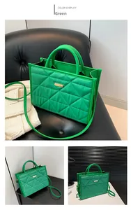 Detail of green nylon quilted tote bag featuring diamond stitching and gold metal plate