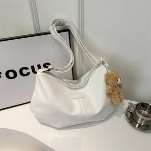 White crescent tote bag in PU leather with plush bear charm and adjustable wide strap