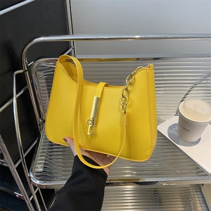 Minimalist bright yellow hobo armpit bag with gold metal buckle and chain strap