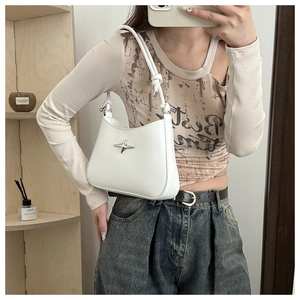 Detail of white PU leather shoulder bag with silver star charm and knotted strap
