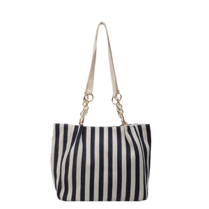 Large striped tote bag with black and white vertical patterns and golden chain straps