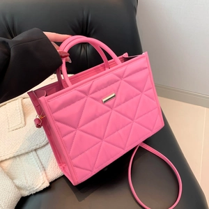 Pink quilted square handbag with chic stitching and metal bar detail for women