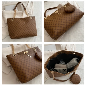 Detail view of large tote bag interior capacity with leather strap and metal charm