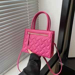 Minimalist pink quilted handbag for women with metallic accents and shoulder strap
