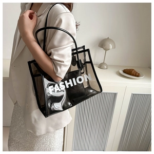 Detail view of large transparent PVC tote bag with removable inner pouch and fashion logo