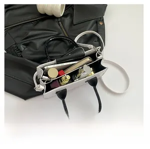 Top view of crocodile pattern bag showing spacious interior with makeup and phone
