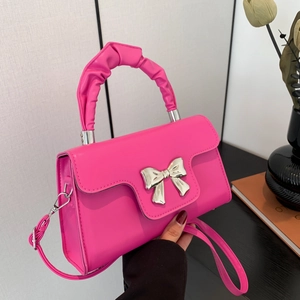 Chic pink mini square bag with silver bow accent and ruched top handle for women
