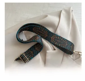 Close-up of adjustable vintage bohemian woven strap with bronze geometric patterns