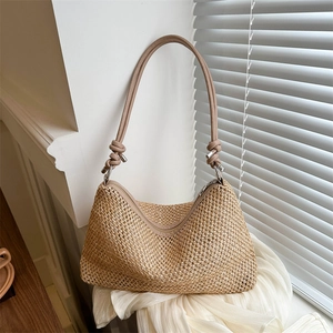 Elegant beige woven straw shoulder bag with leather straps for beach holidays