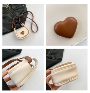 Detail of mini crossbody bag with contrast heart ornament and fine stitching