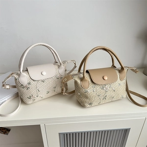 Straw woven handbag with floral embroidery and PU leather trim in ivory and khaki colors