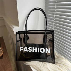 Modern transparent PVC tote bag with black leather trim and 'FASHION' text print