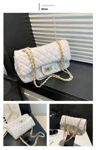 Detailed close-up of white quilted leather bag with golden chain and square twist lock
