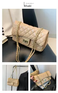 Detail of khaki quilted shoulder bag with golden chain strap and metallic turn-lock closure