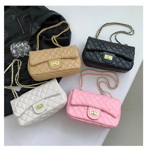 Detailed overhead view of four quilted flap bags in beige, black, white, and pink leather