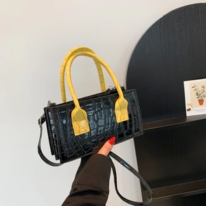 Minimalist black crocodile pattern handbag with yellow handle and multi-layer design
