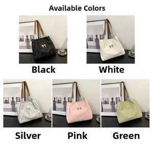 Close-up of pleated tote bags with metallic bow details in five vibrant colors