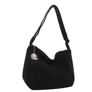 Minimalist black corduroy tote bag with cute dog charm and adjustable shoulder strap