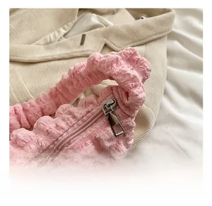 Detail of metal zipper and pink bubble textured fabric on Korean style shoulder bag