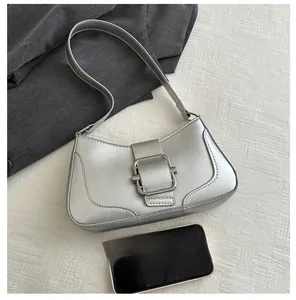 Silver baguette shoulder bag with metal buckle and mobile phone for size reference