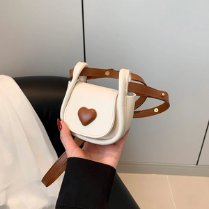 Mini heart-shaped crossbody bag in cream and brown PU leather with adjustable strap