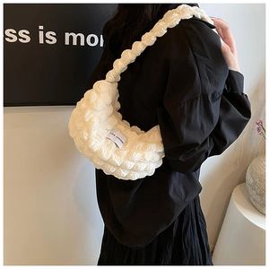 Detailed view of white pleated bubble bag with waffle texture and LOVE FASHION label