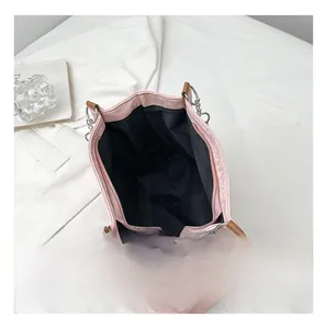 Interior view of pink tote bag showing spacious black lining and zip pocket detail