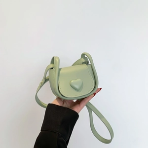Light green heart-shaped mini crossbody saddle bag with adjustable shoulder strap